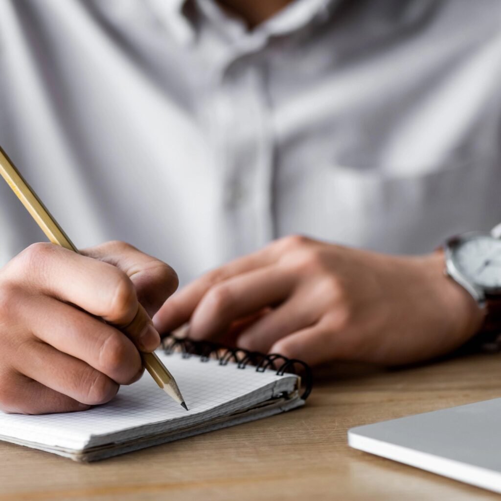 Man writing on a notepad